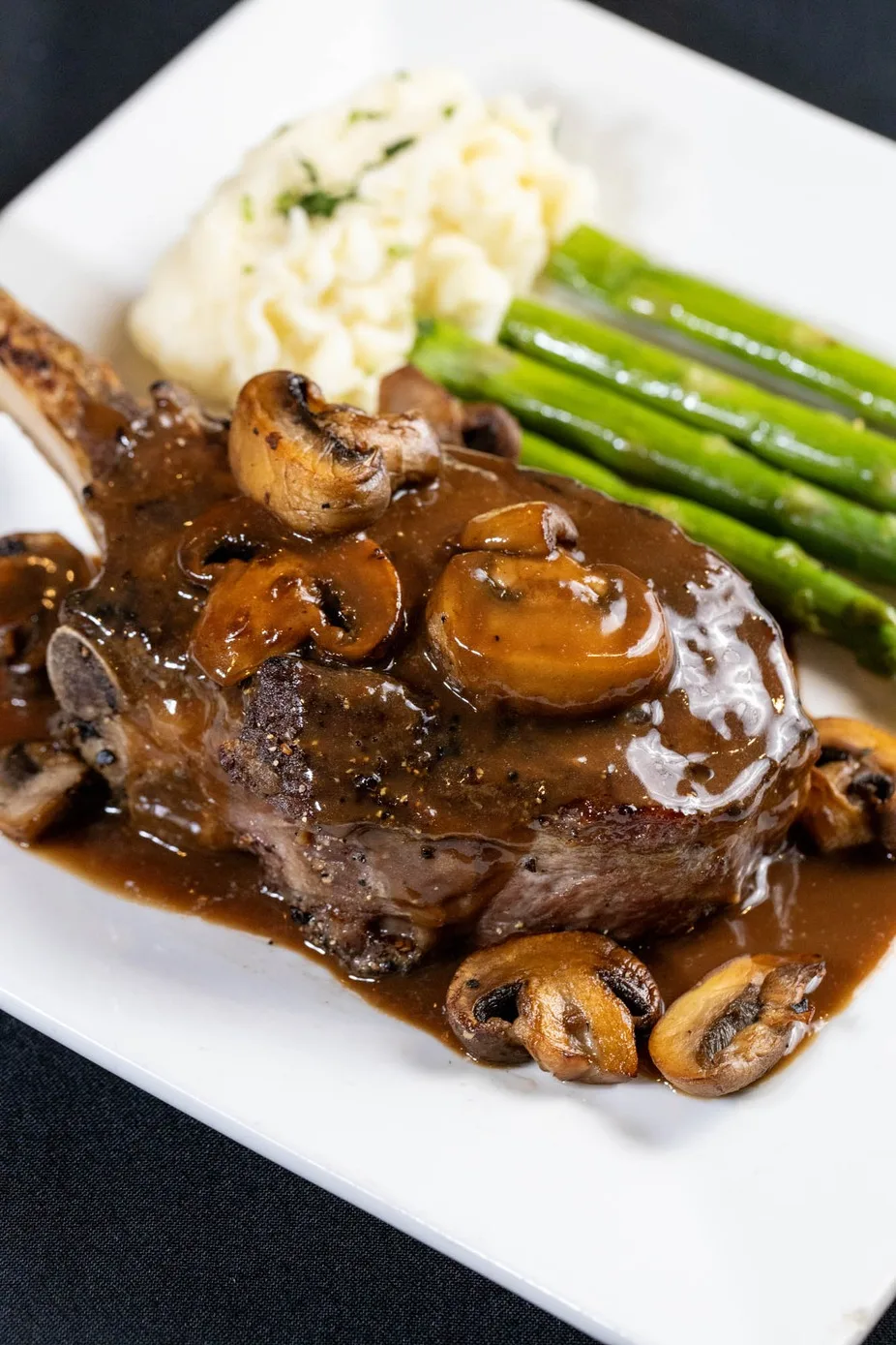 Bone-in chop with mushrooms and asparagus
