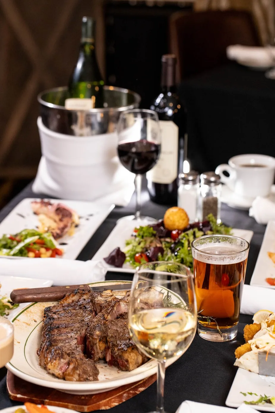 Dinner table with wine and steak