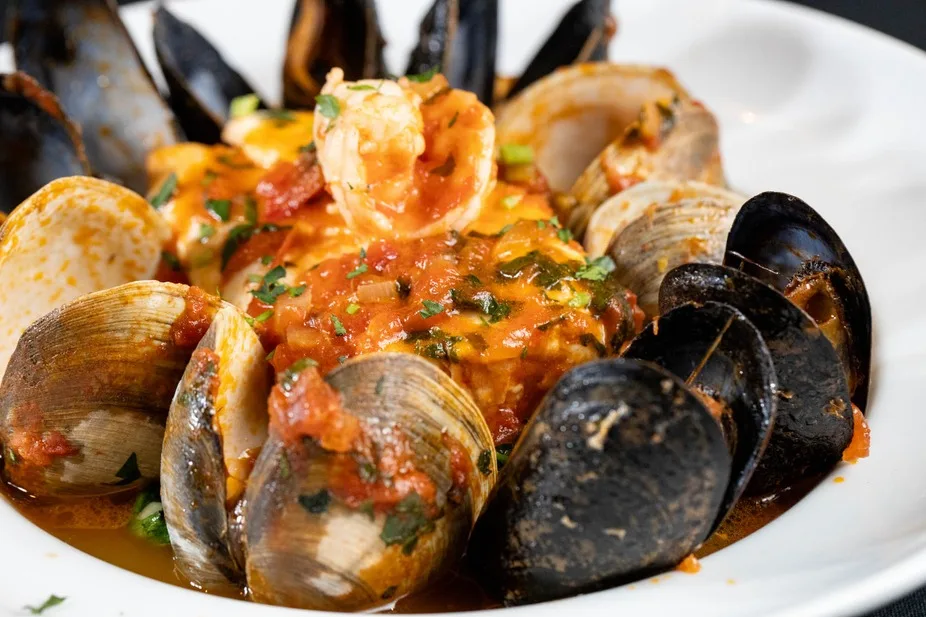 Bowl of seafood stew with clams, mussels and tomato broth